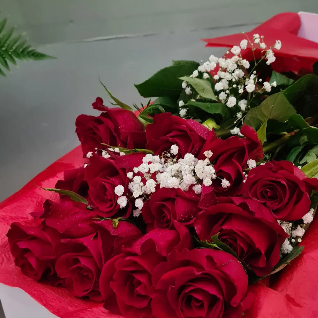 Long red roses in presentation box